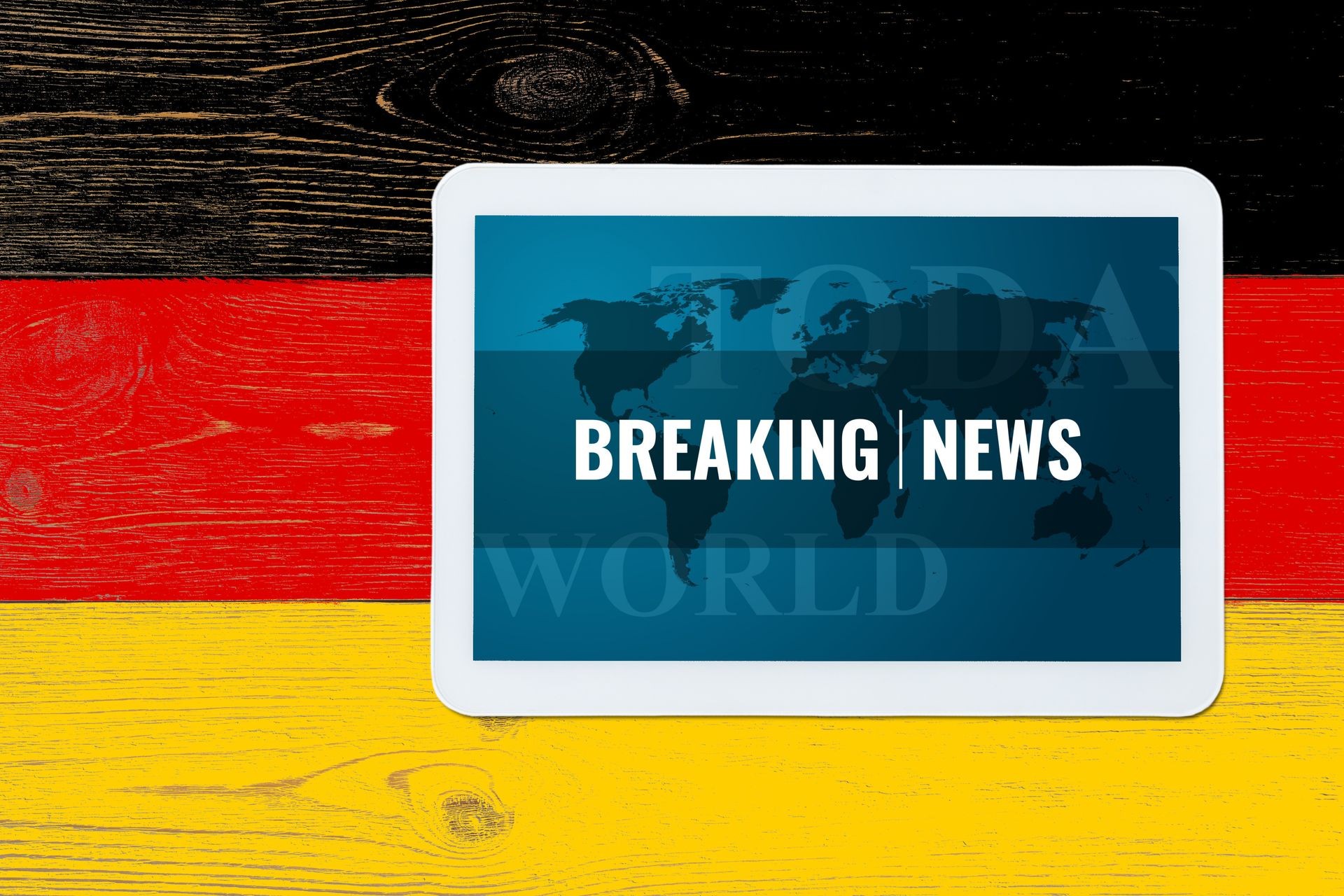 breaking news splash screen on tablet pc over painted germany flag